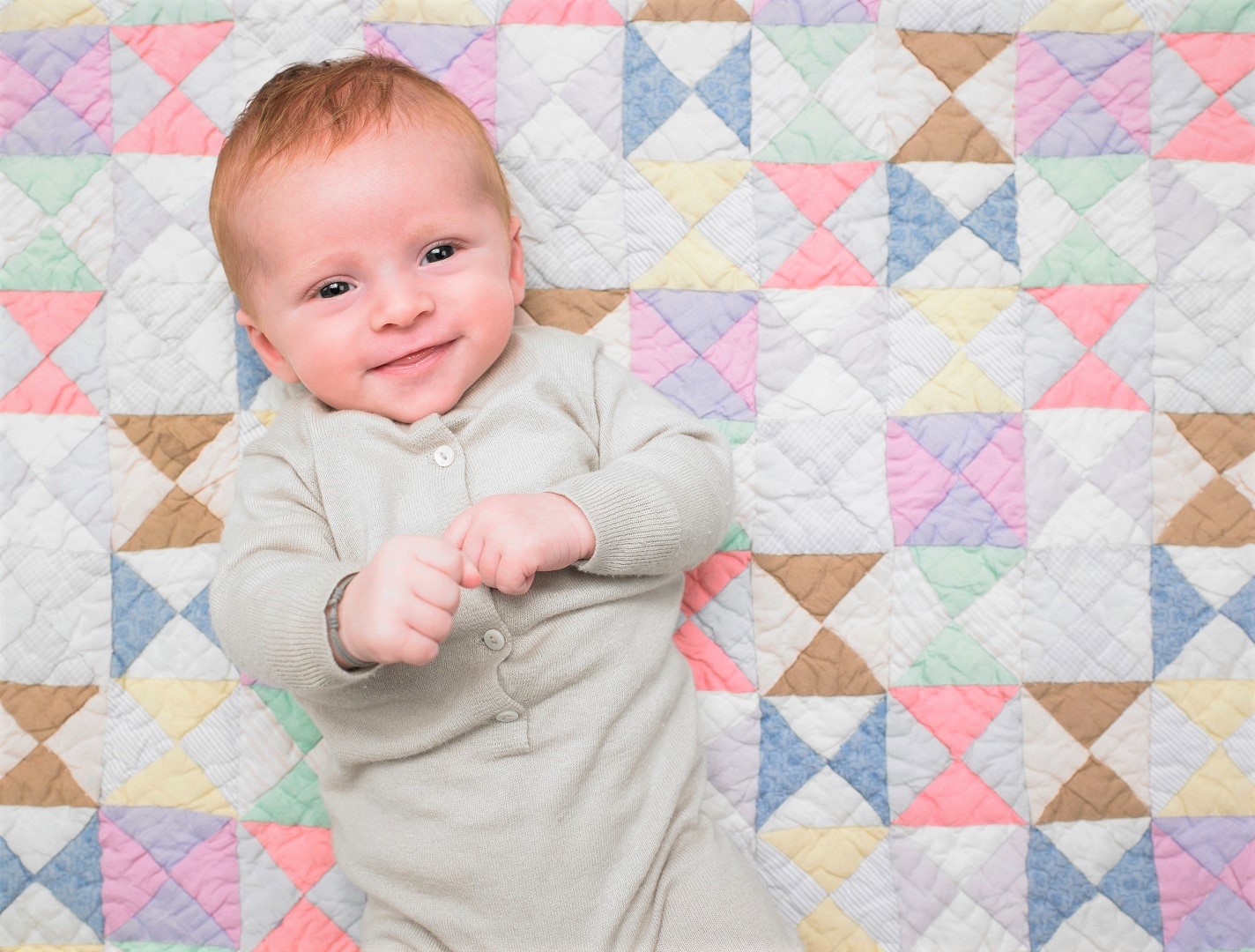 Baby on Colorful Quilted Blanket