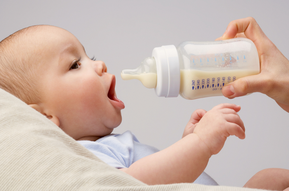 baby being formula fed with bottle