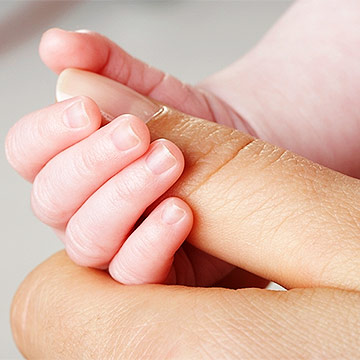 Woman holding baby's hand