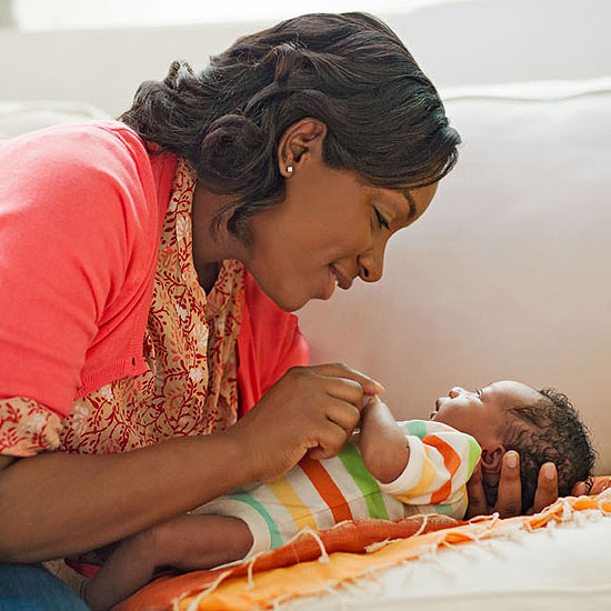 woman playing with baby