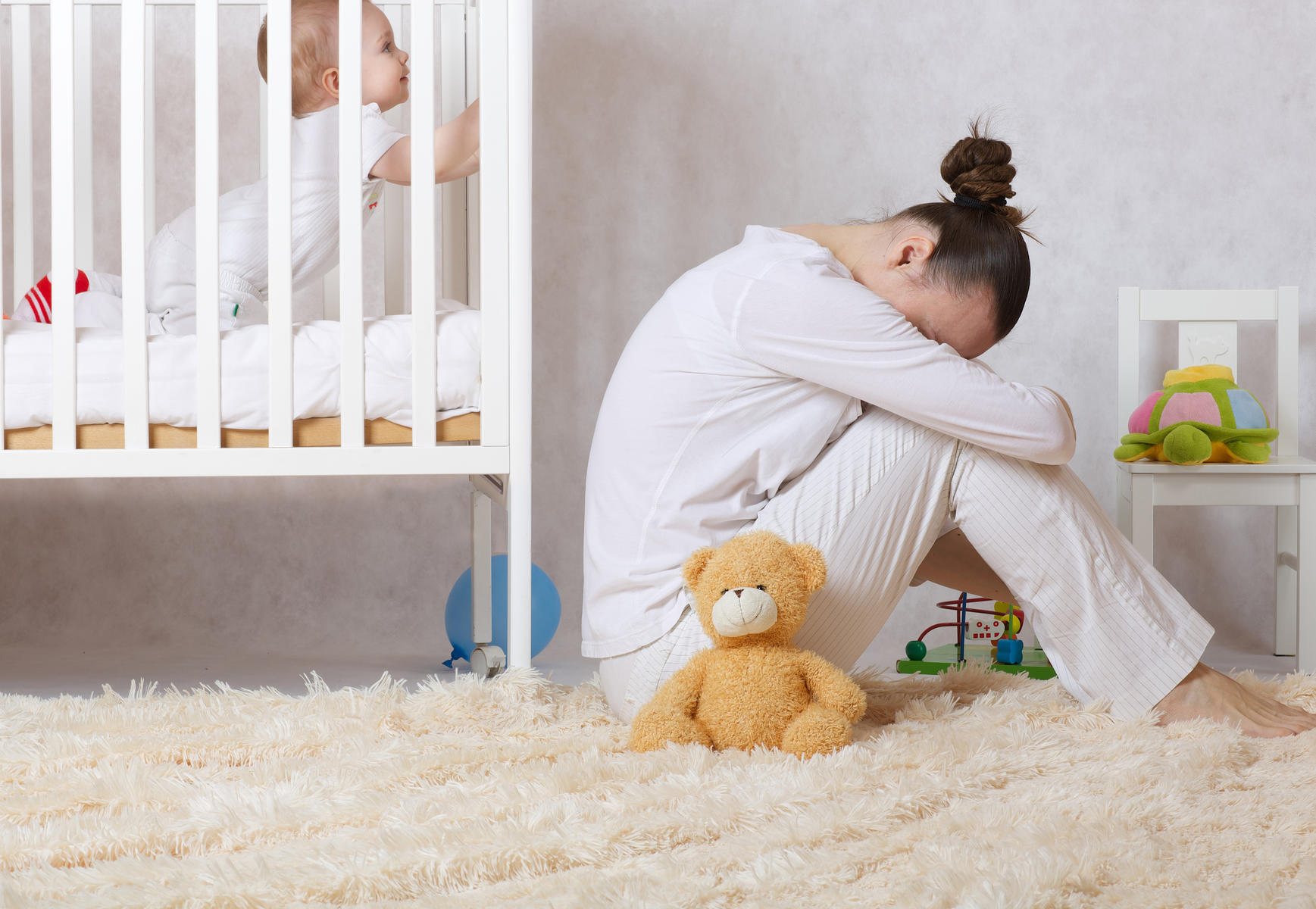 Postpartum Depression mom near baby crib