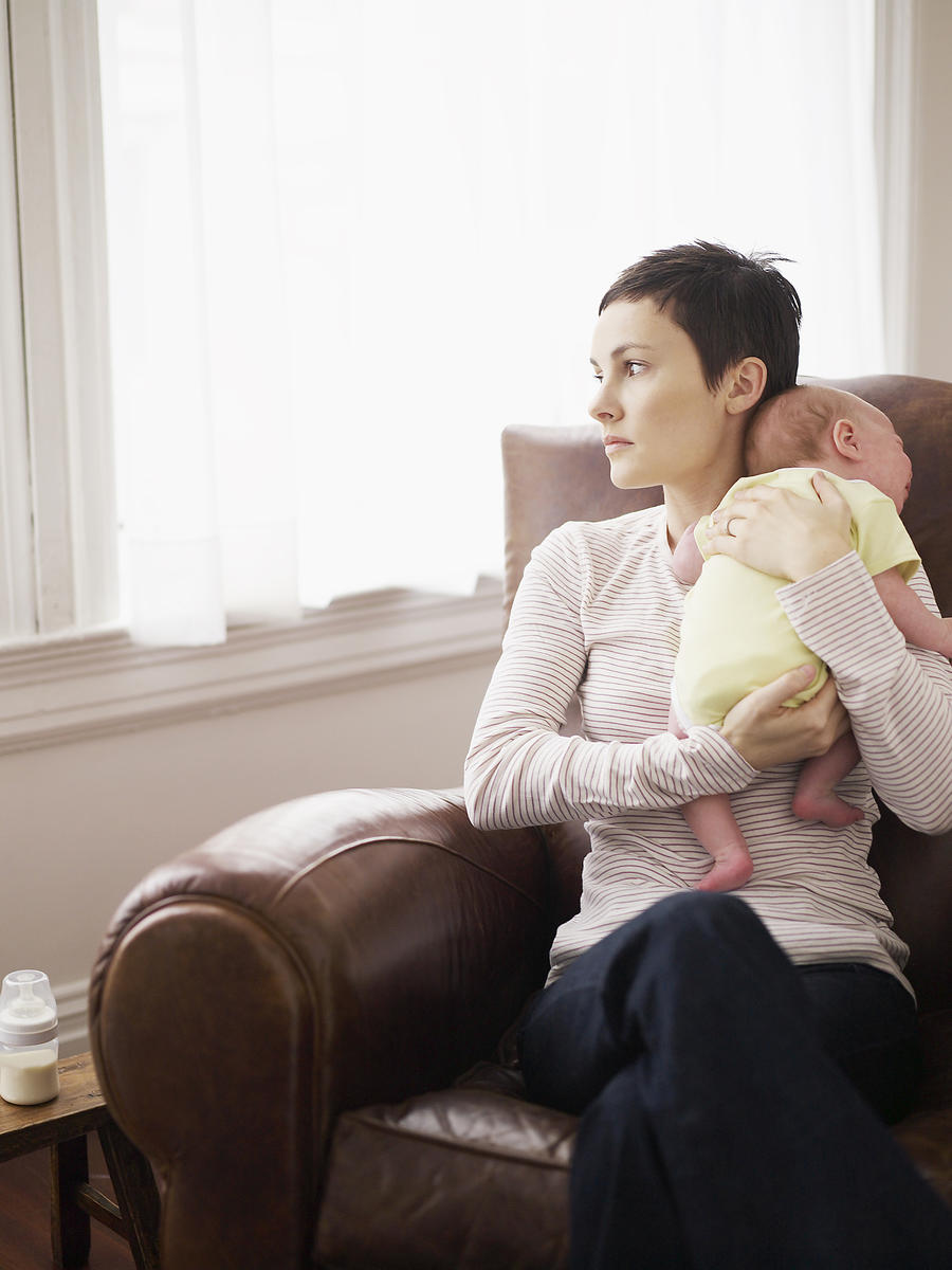 Mom holding baby looking out window