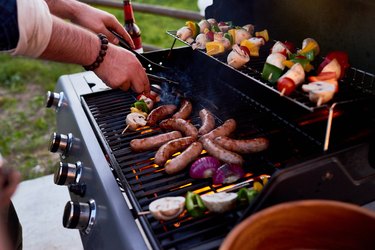 Sausages and shish kebabs on grill