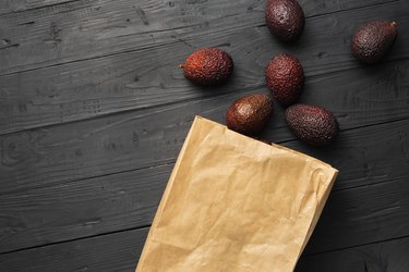 Avocados next to paper bag