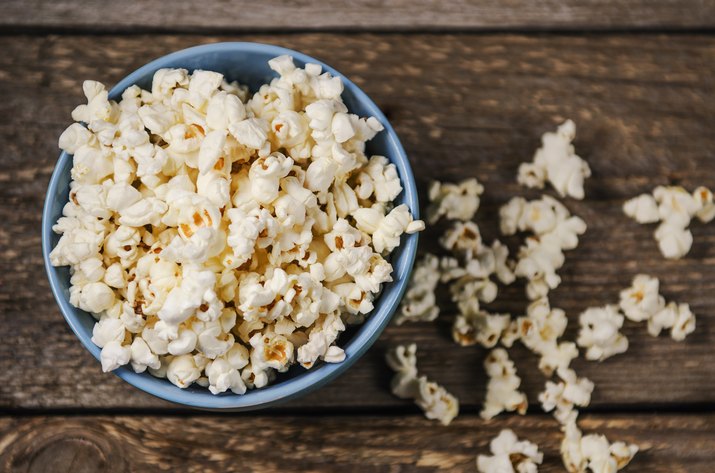 Popcorn in a bowl on wooden table