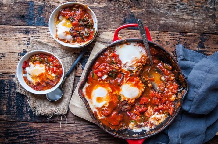 Shakshuka baked in a cast iron skillet, served hot