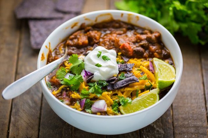 A white bowl of brightly colored chili