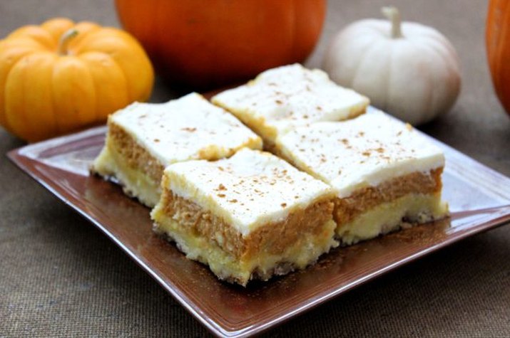 Four pumpkin crisp bars on a square plate