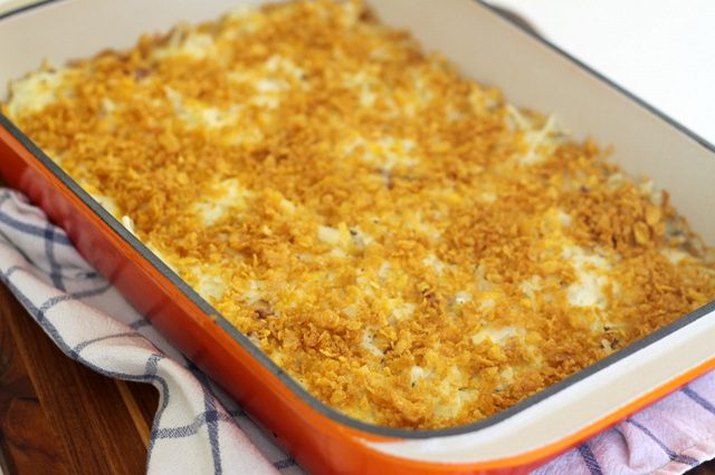 A dish filled with a freshly baked cheesy potato casserole.