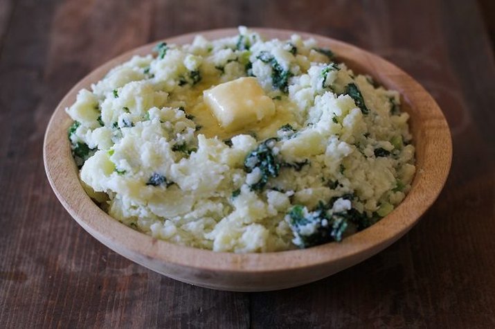 A bowl of Irish Mashed Potatoes topped with butter.