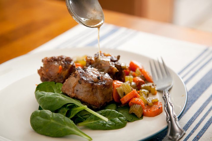 plate of oxtails and vegetables