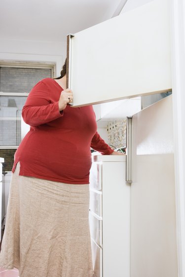 Woman looking in refrigerator